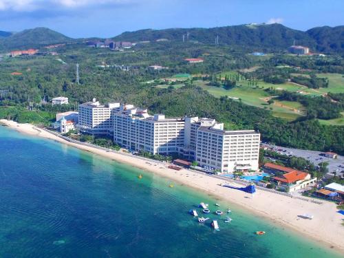 an aerial view of a beach and buildings at Rizzan Sea Park Hotel Tancha Bay in Onna