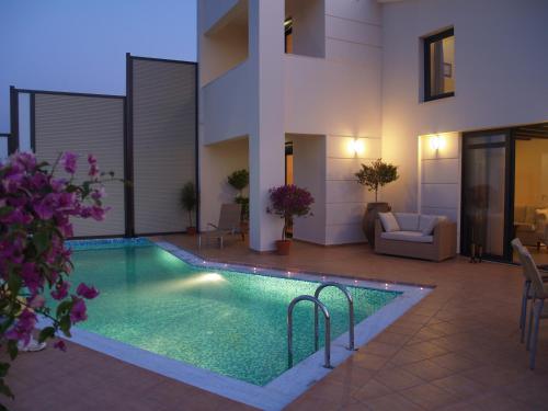 a swimming pool in the middle of a house at Villa Rotunda A in Kolymvari