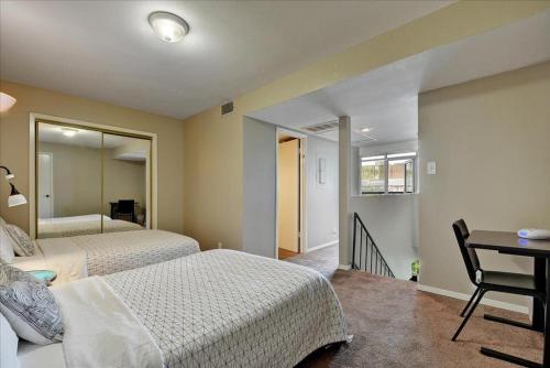 a bedroom with two beds and a table and a desk at Littlefield Lofts #308 in Austin