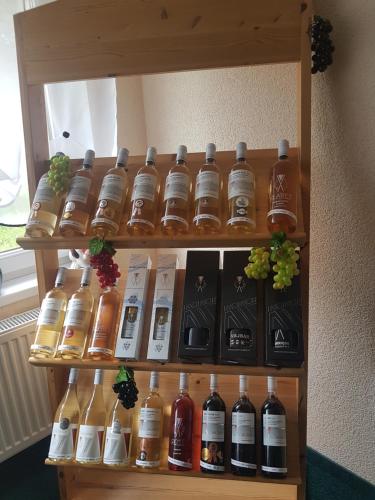 a shelf with many bottles of alcohol on it at Pension Sunset Mezirolí in Nová Role