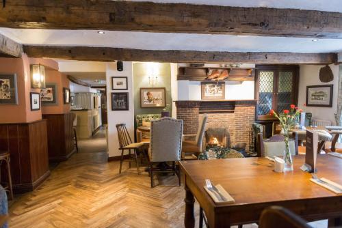 a kitchen with wooden floors and a wooden table at The Horse and Farrier Inn and The Salutation Inn Threlkeld Keswick in Threlkeld