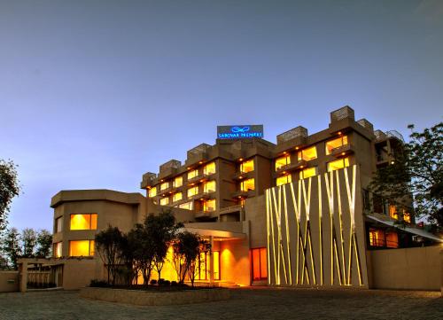 a large building with lights on in front of it at Sarovar Premiere Jaipur in Jaipur