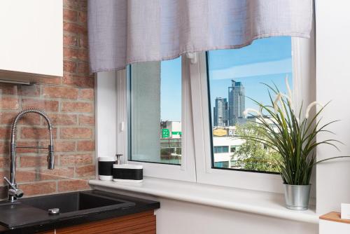 a kitchen window with a view of a city skyline at Apartament ProBaltica II Gdynia in Gdynia