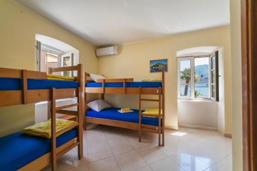 a room with bunk beds in a house at Montenegro Hostel 4U in Kotor