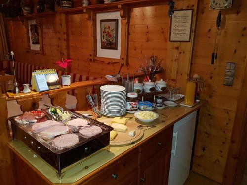 a kitchen with a counter with food on it at Pension Bergkristall in Tux