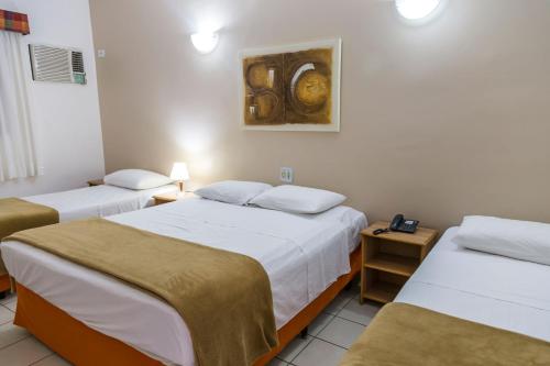 En eller flere senge i et værelse på Resort Recanto do Teixeira All Inclusive