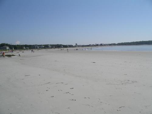 a group of people walking on the beach at Rhumb Line Resort in Kennebunkport