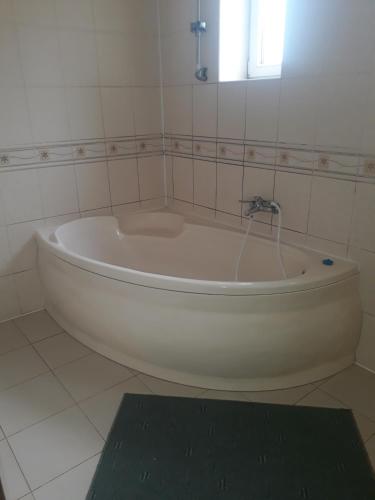 a bath tub with a faucet in a bathroom at Hotel Alfa in Mukacheve
