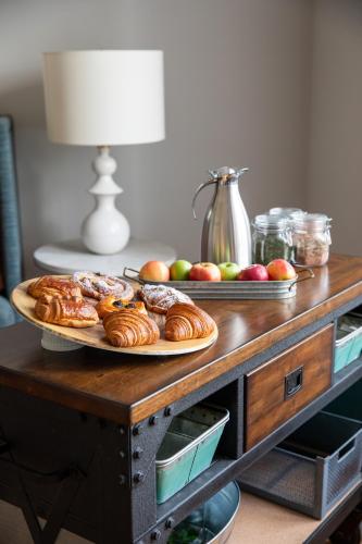 a table with a plate of pastries and apples on it at The Blackburn Inn and Conference Center in Staunton