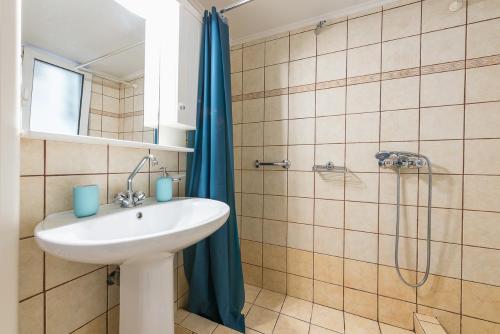 a bathroom with a sink and a shower at Just Under Acropolis in Athens