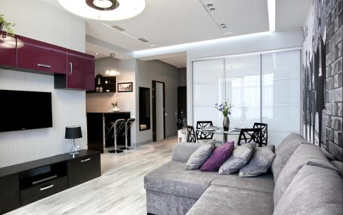 a living room with a gray couch and a table at Beach & Beatles Apartments in Odesa