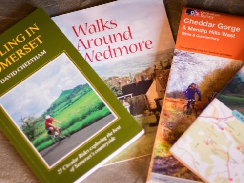three books sitting next to each other on a table at Pear Tree Cottages in Wedmore