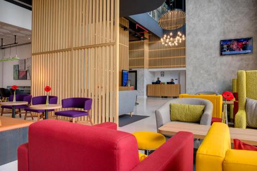 a lobby with colorful chairs and tables at Park Inn by Radisson, Nairobi Westlands in Nairobi