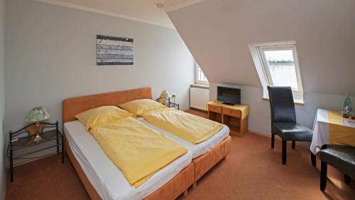 a bedroom with a bed and a desk and a chair at Achilleon III in Geesthacht