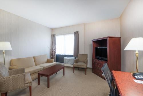 a living room with a couch and a tv at Ramada by Wyndham St. John's in St. John's