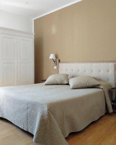 a bedroom with a large bed with two pillows at Hotel Piccolo Mondo in Lido di Camaiore