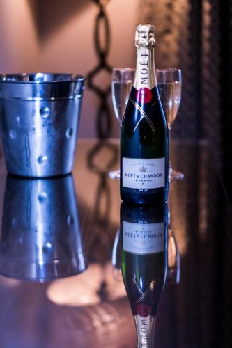 a bottle of wine sitting on a table with glasses at Parklands Hotel & Country Club in Newton Mearns