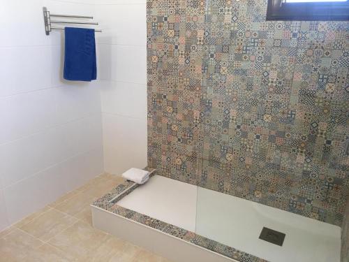 a bathroom with a shower with a glass door at Vila Praia Apartment in Albufeira