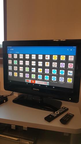 a computer monitor sitting on a desk with two remote controls at Vlašićka priča Eko Fis in Vlasic