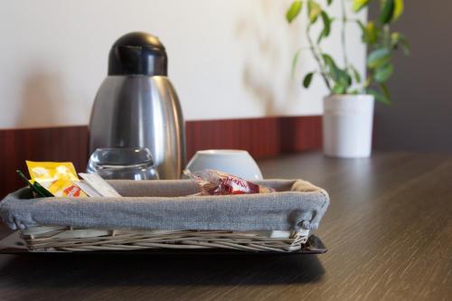 a basket of food is sitting on a table at The Originals City, Le Mas de Grille, Montpellier Sud in Saint-Jean-de-Védas