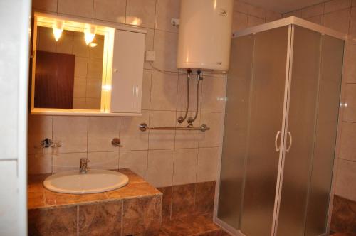 a bathroom with a sink and a shower at Apartments Kalsan in Novalja