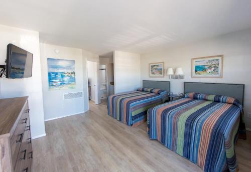 a bedroom with two beds and a television in it at The Southwinds in Cape May
