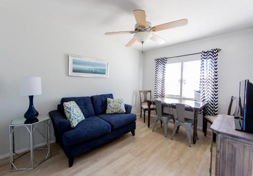 a living room with a blue couch and a table at The Southwinds in Cape May