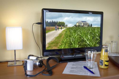a computer monitor sitting on top of a desk at Hotel Perekop in Berdorf