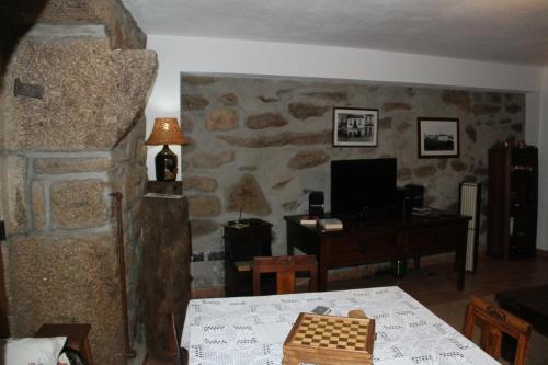 a living room with a table and a desk with a chessboard at Alojamento Rural Casa da Eira in Murça