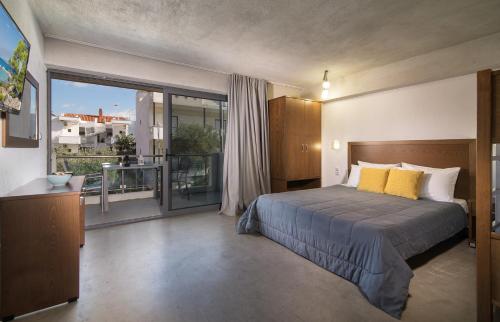 A bed or beds in a room at Erifili at Sarti Agora Apartments & Studios