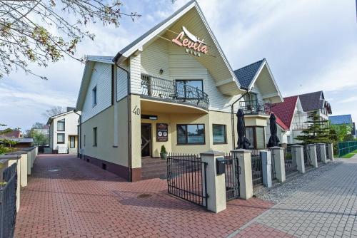 a building with a sign on the side of it at Vila Levita in Palanga