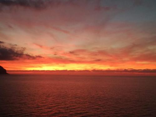 a sunset over a body of water at Sciascia Apartment in Marina di Palma