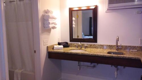 a bathroom with a sink and a mirror at Sea Shell Motel in Chincoteague
