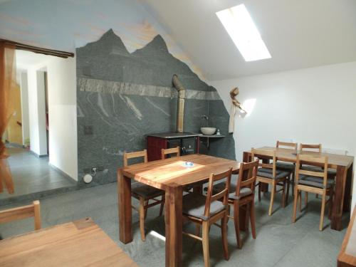 a dining room with wooden tables and chairs at Guesthouse "Castello del Nucleo" in Intragna