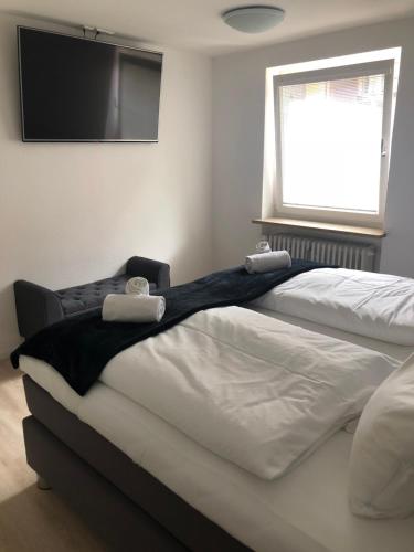 a bedroom with two beds and a flat screen tv at Sanosueno 1 in Sonthofen