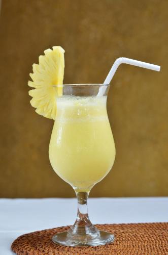 a drink in a glass with a lemon twist at Sedok Jineng Villa Lembongan in Nusa Lembongan