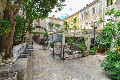 a patio with a bunch of plants and trees at Old Town Skyline apartment 3 in Budva