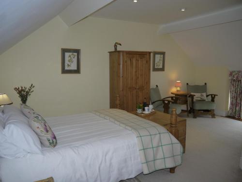 a bedroom with a bed and a table and a chair at Rectory Farm in Levisham