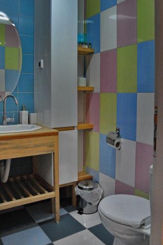 a colorful bathroom with a sink and a toilet at Apartmani15 in Arandjelovac