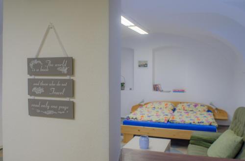 a bedroom with a bed with a sign on the wall at Jüstel apartment in Litoměřice