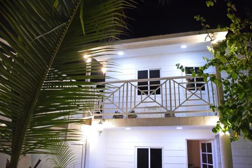 a white house with a balcony at night at Le Castel Blanc Hotel Boutique in San Andrés