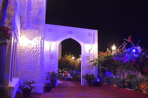 a white entrance to a building with flowers and plants at Le Castel Blanc Hotel Boutique in San Andrés