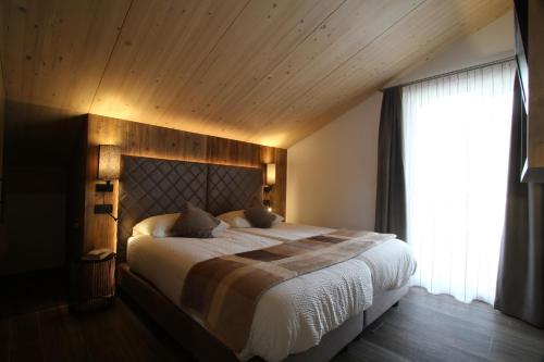 een slaapkamer met een groot bed en een raam bij Chalet Teresa in Livigno