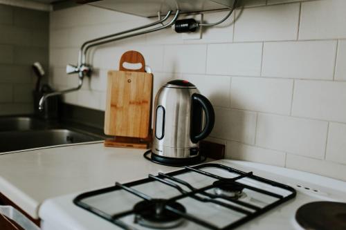 a tea kettle sitting on top of a stove in a kitchen at Apartments Doulos in Splitska