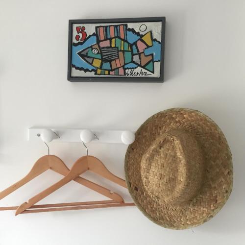 a hat and hangers in a room with a picture at Le Pas Saint Joseph in Saint Malo