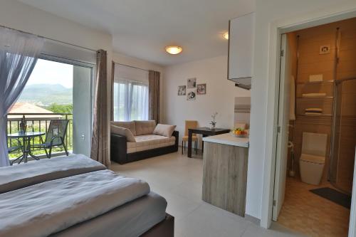 a bedroom with a bed and a living room at Kristina Apartments in Tivat