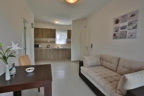 a living room with a couch and a table at Kristina Apartments in Tivat