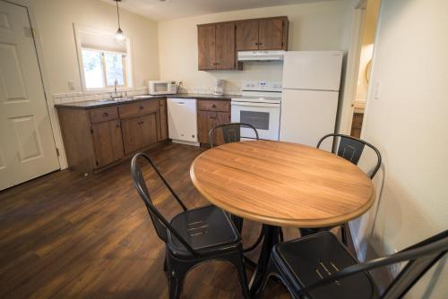 a kitchen with a wooden table and chairs in a kitchen at Eagle Cap Chalets in Joseph