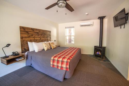 a bedroom with a large bed and a ceiling fan at Eagle Cap Chalets in Joseph