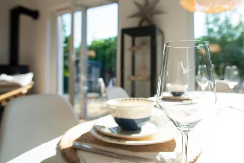 een tafel met een wijnglas en een kopje erop bij 365PAM - Marina i Dom Rodzinny - BASEN ZEWNĘTRZNY, KORT TENISOWY, SIŁOWNIA, PLAC ZABAW, BOISKO in Ustronie Morskie